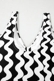 Black and white wave print one-piece swimsuit with V-neckline and bow detail