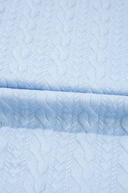 Light blue loungewear set with cable knit trim and chevron pattern detail.