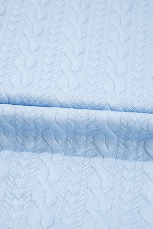 Light blue loungewear set with cable knit trim and chevron pattern detail.