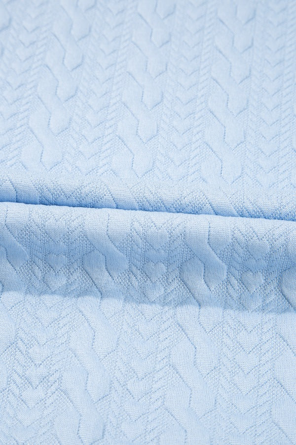 Light blue loungewear set with cable knit trim and chevron pattern detail.