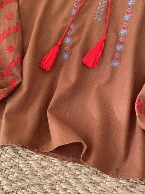 Embroidered folk-inspired tie neck shirt in apricot, brown, white, or khaki.