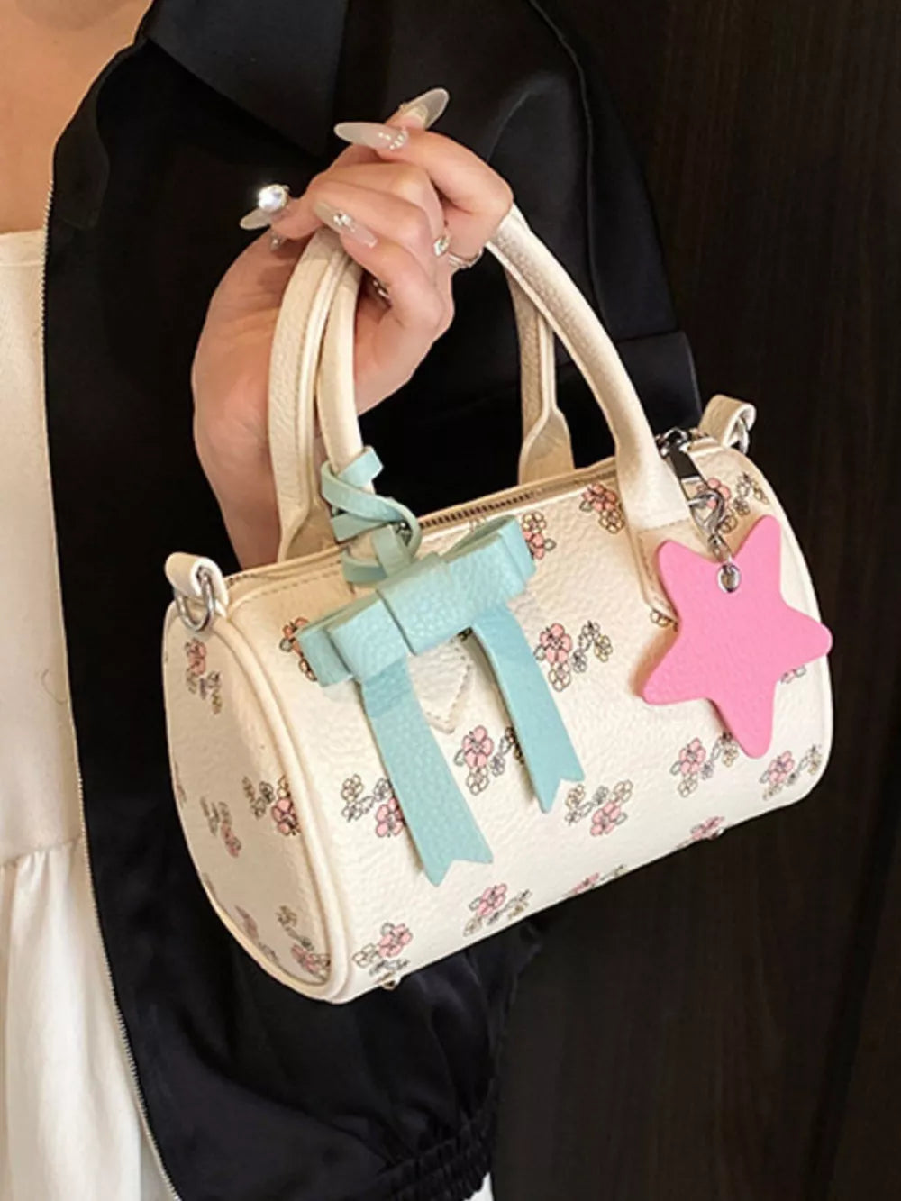 Charming floral mini crossbody bag with blue bow and pink star charm.