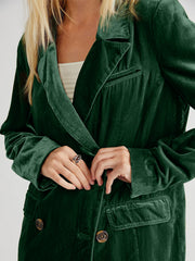 Dark green velvet double-breasted blazer with patch pockets and tortoiseshell buttons.
