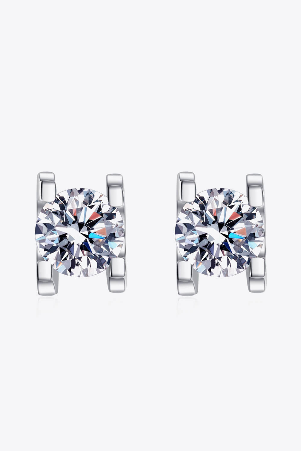 Silver moissanite stud earrings with sculpted settings.