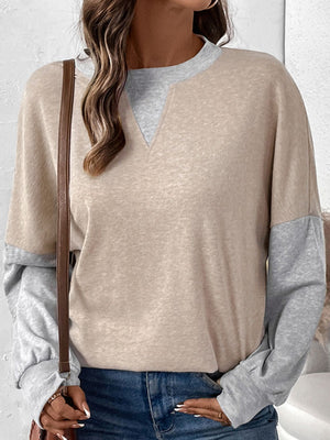 Layered V-neck sweatshirt in tan and gray colorblock with long sleeves.
