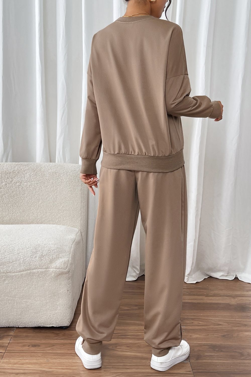 Camel relaxed fit loungewear set with crewneck sweatshirt and wide-leg pants.