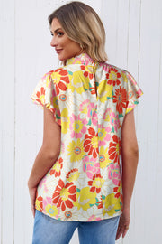 Retro floral blouse with smocked neckline and butterfly sleeves.