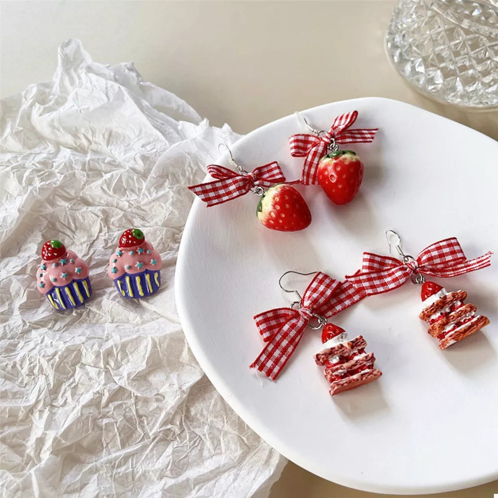 Charming strawberry dangle earrings with red gingham bow accents