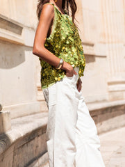Light Green sequin embellished tank top with frayed hem, styled with white pants.