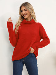 Textured knit oversized turtleneck pullover in deep red acrylic, with a relaxed fit and long sleeves.