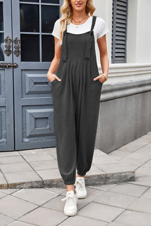 Dark Gray corduroy overalls with tie straps, V-neck, and barrel leg cut.
