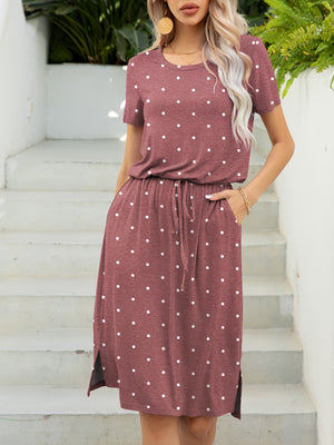 Drawstring waist midi dress in Moonlit Mauve with white polka dots, short sleeves, and side slits.