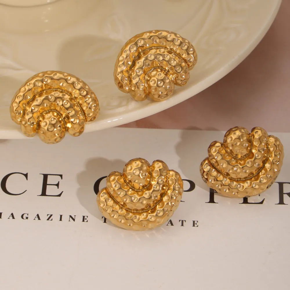 Gold textured shell stud earrings with hammered finish
