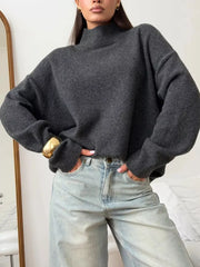 Relaxed mock neck sweater in dark gray acrylic blend with dropped shoulders and cuffed sleeves.