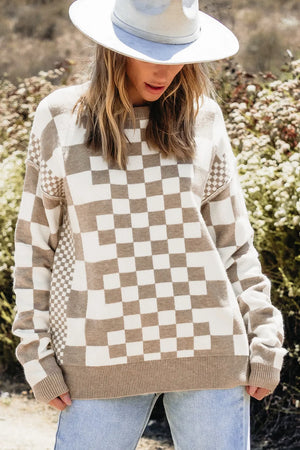 Geometric knit checkerboard pullover sweater in mocha and white with crew neck and long sleeves.