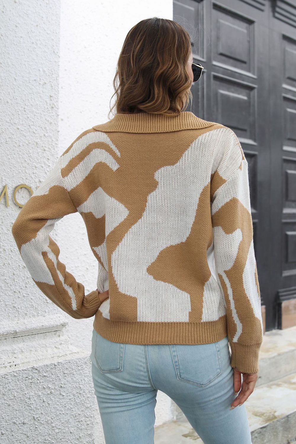 Women's camel and white abstract print polo knit sweater with collared neckline.