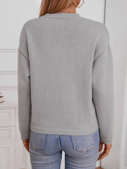 Gray knit sweater with notched neckline and ribbed trim.