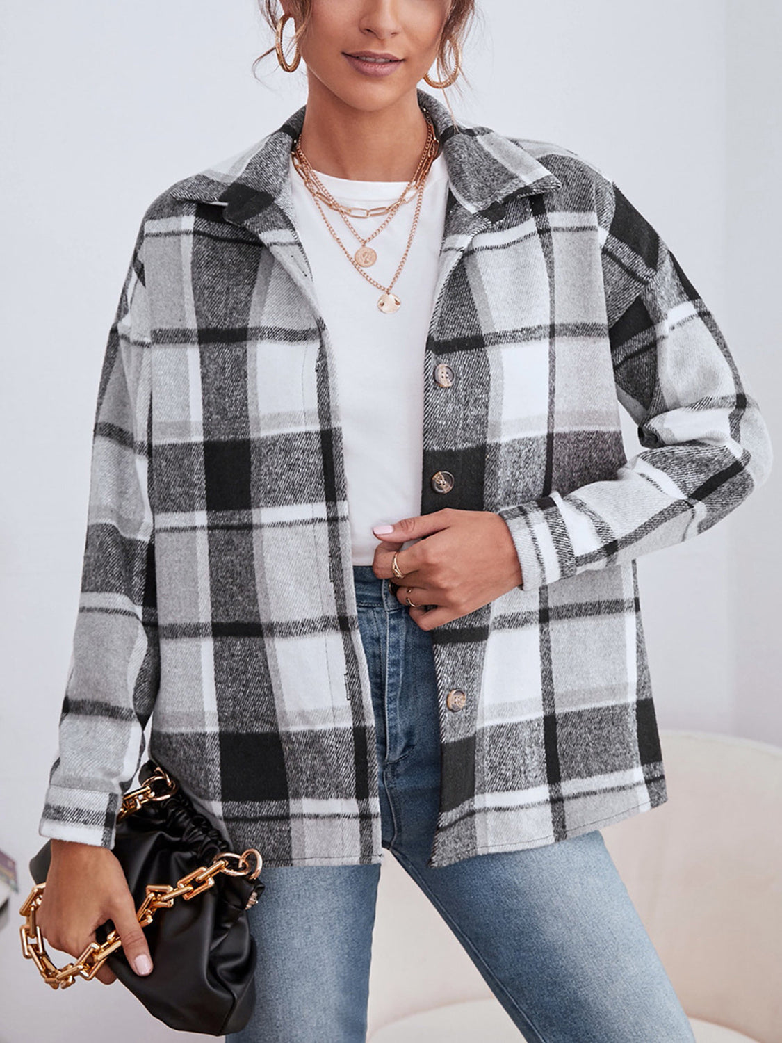 Oversized plaid shacket with button closure in black, white, and gray.