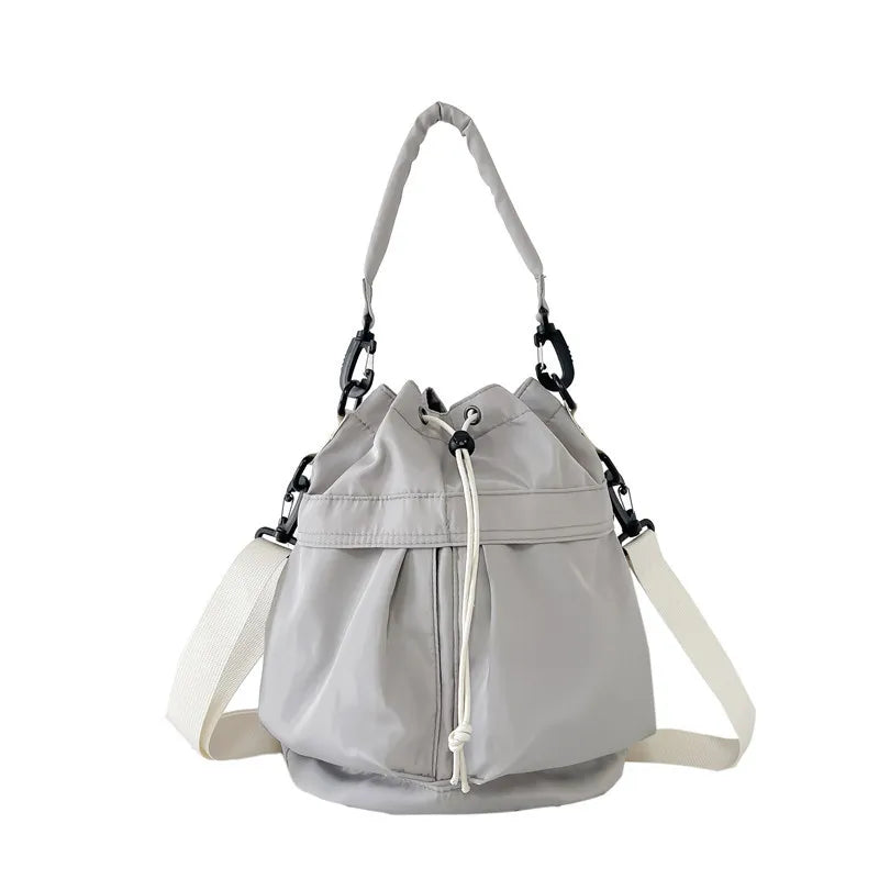 Light Gray nylon drawstring bucket bag with white strap and chain detail