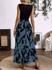 Maxi dress with black top and blue grey floral skirt, belted detail, sleeveless.