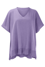Relaxed V-neck knit poncho top in lavender with ribbed hem and short sleeves.