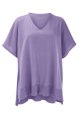 Relaxed V-neck knit poncho top in lavender with ribbed hem and short sleeves.