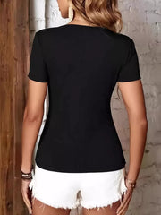 Black ribbed short sleeve tee with zipper detail, paired with white denim shorts.