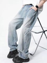 Light wash wide-leg denim jeans with a vintage fade and relaxed fit.