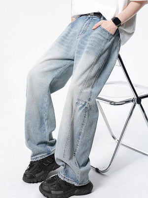 Light wash wide-leg denim jeans with a vintage fade and relaxed fit.