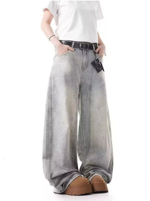 Men's light wash baggy jeans with a belted waist and wide leg.