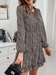 Ruffled tie neck floral mini dress in dark brown with long sleeves and a tiered hem.