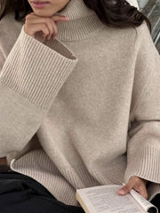 Khaki ribbed turtleneck sweater with flared sleeves and a relaxed fit.