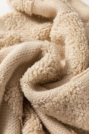 Beige textured checkerboard knit sweater with plush lining detail