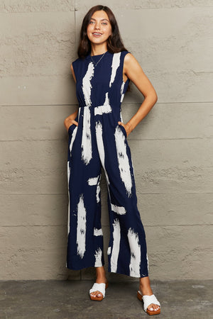 Navy brushstroke print jumpsuit with keyhole back and wide legs.