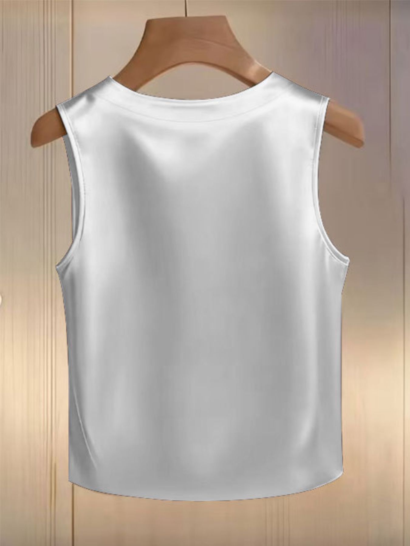 White satin tank top with pearl embellishments and a round neckline.
