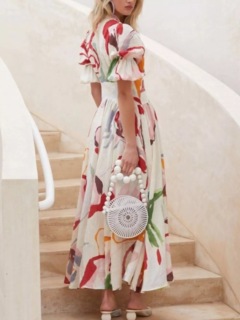 White abstract print midi dress with puff sleeves and button front.