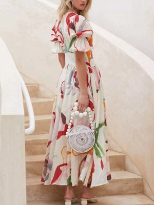 White abstract print midi dress with puff sleeves and button front.