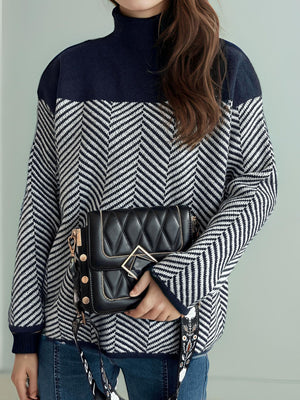 Chevron knit turtleneck sweater with colorblock navy yoke and cuffs.
