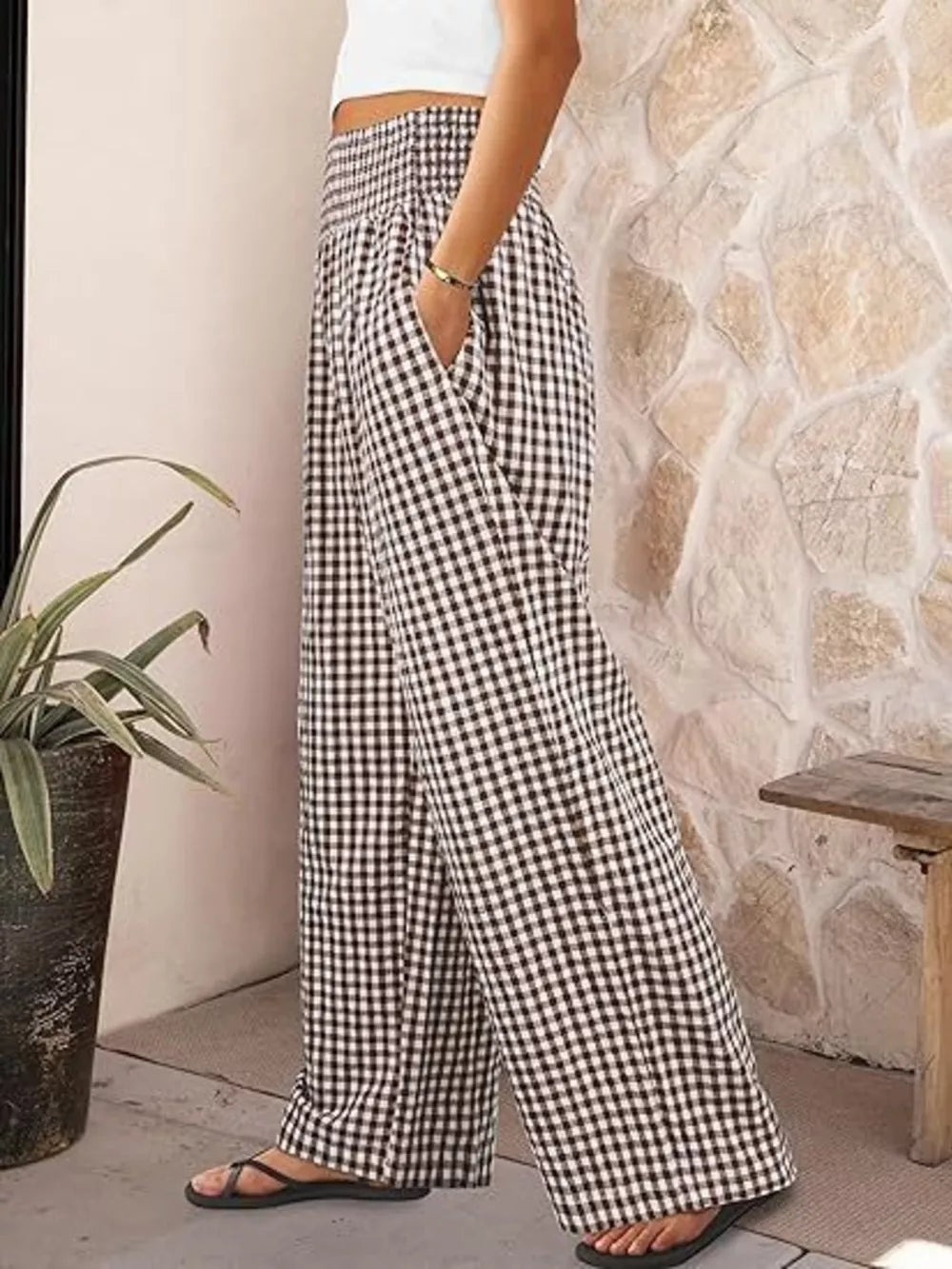 Gingham wide-leg maternity pants in black plaid with a smocked waistband and pockets.