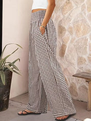 Gingham wide-leg maternity pants in black plaid with a smocked waistband and pockets.