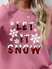Blush pink crewneck sweatshirt with "Let It Snow" graphic in buffalo plaid and snowflakes.