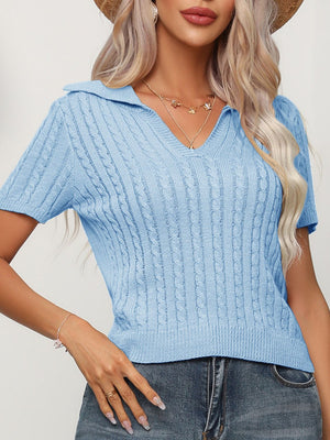 Light blue cable knit short sleeve polo sweater with a v-neck.