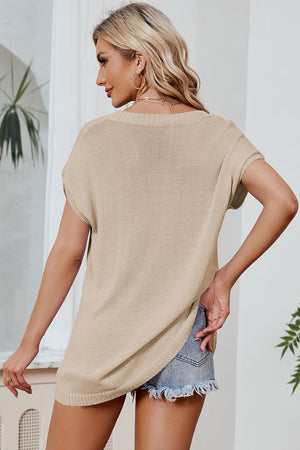 Tan knit tee with dolman sleeves and a relaxed fit, styled with denim shorts.