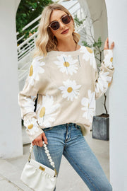 Beige intarsia knit sweater with daisy pattern and crew neck.