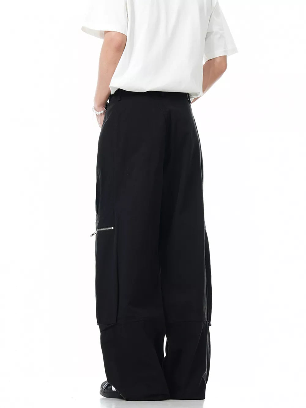 Black men's cargo pants with zippered pocket detail and wide leg.