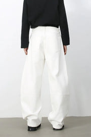 Sculpted white denim balloon trousers with a high waist and wide leg, shown from the back.