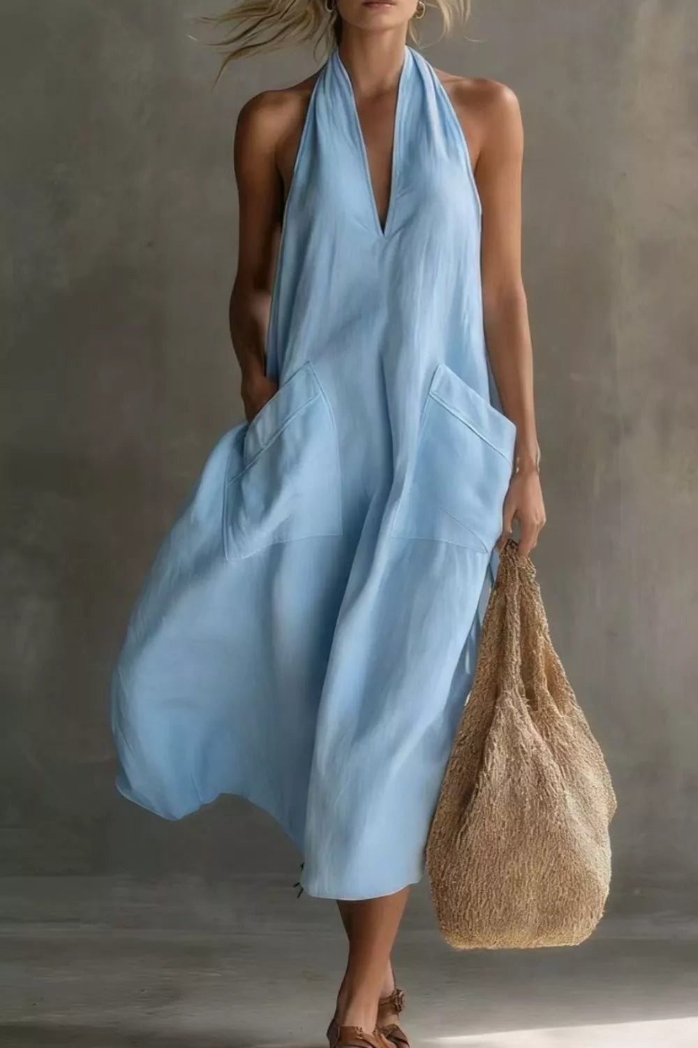 Light blue halter midi dress with pockets and a V-neckline.