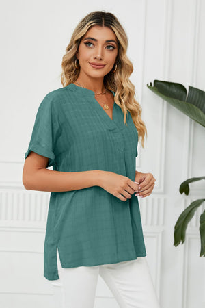 Turquoise linen blouse with V-neck, short sleeves, and subtle grid pattern.