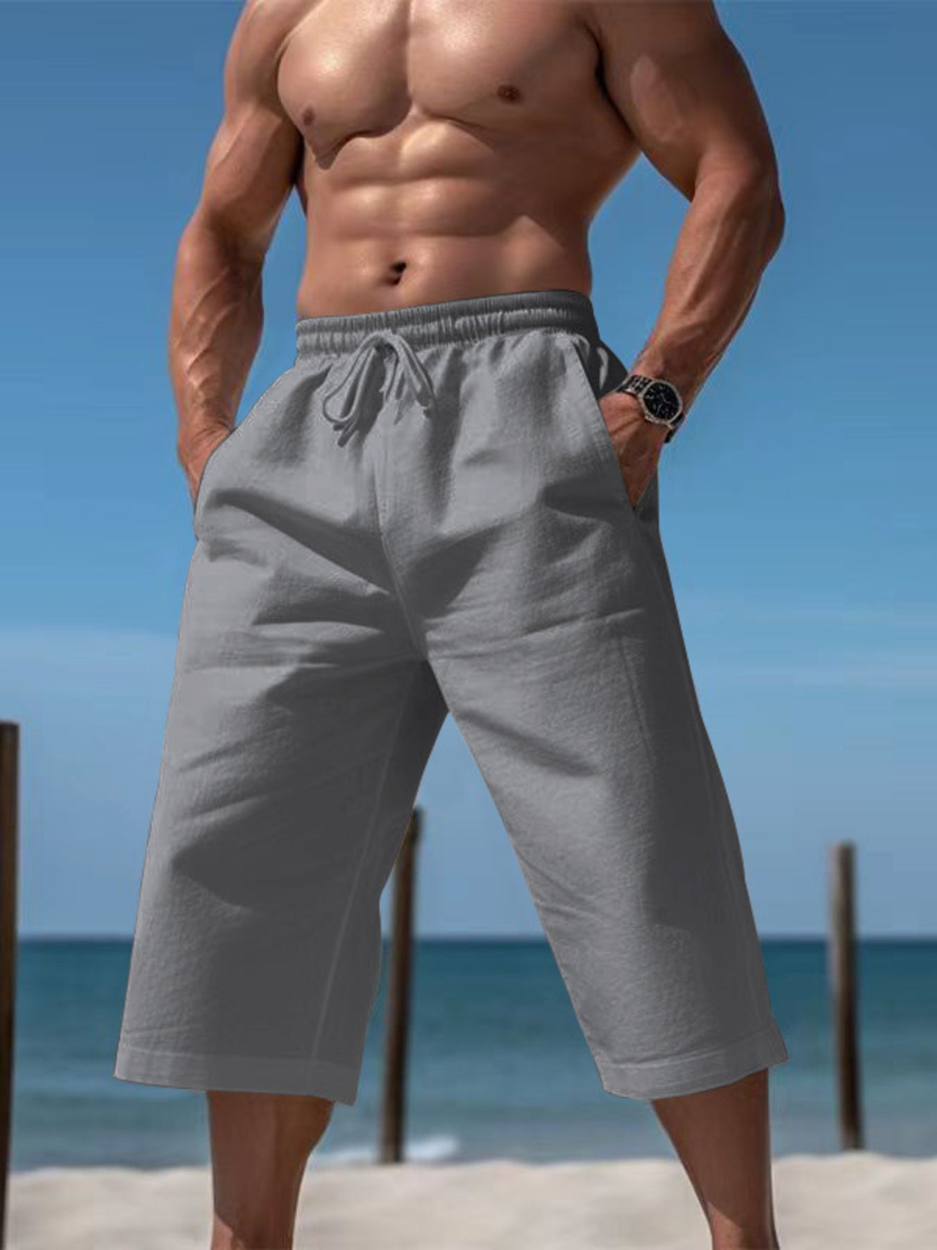 Men's grey relaxed fit drawstring cropped sweatpants with pockets.