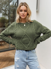 Moss green acrylic cable knit cropped sweater with diamond pattern detail.